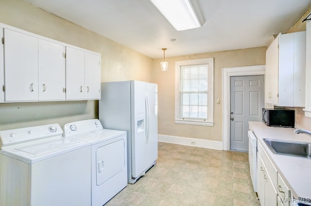 laundry room with washer and dryer and sink