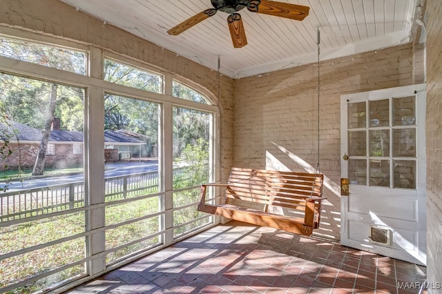 sunroom featuring ceiling fan and wooden ceiling