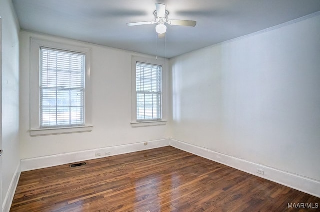 empty room featuring dark hardwood / wood-style flooring and ceiling fan