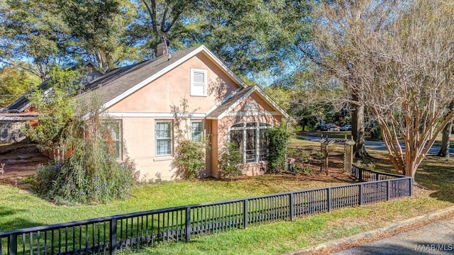 view of side of property with a yard