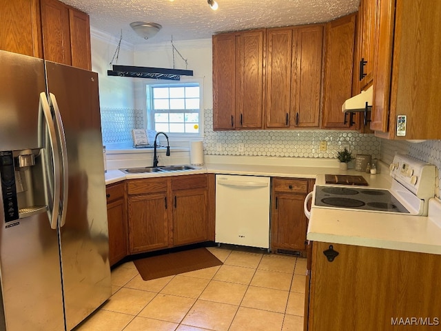 kitchen with backsplash, a textured ceiling, white appliances, sink, and light tile patterned floors