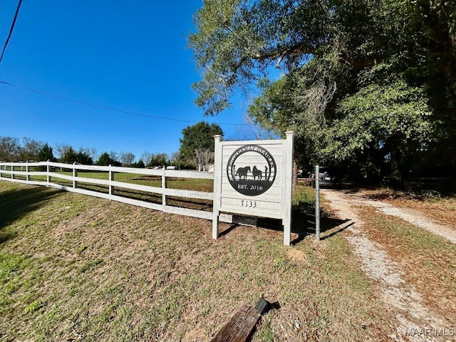 community sign featuring fence