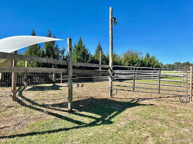 view of yard featuring a rural view and an outdoor structure