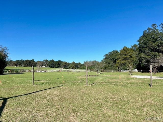 view of home's community with a rural view and a yard