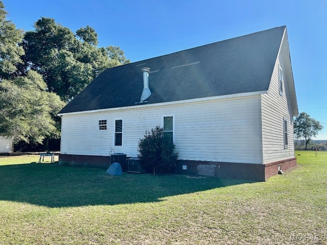 view of home's exterior with a lawn and cooling unit