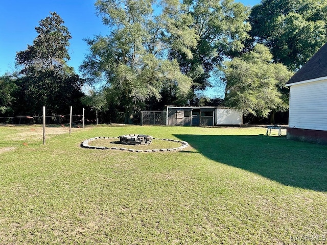 view of yard with a fire pit and a shed