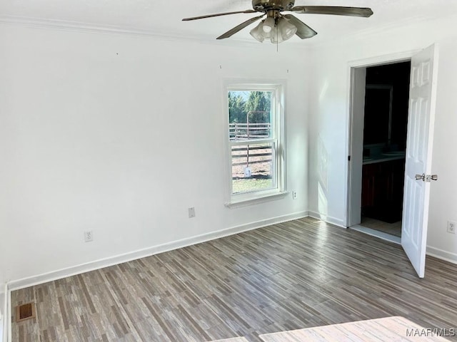 unfurnished room with hardwood / wood-style flooring and ornamental molding