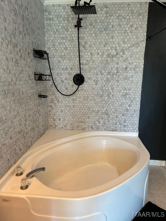 bathroom featuring tile patterned flooring and a tub to relax in