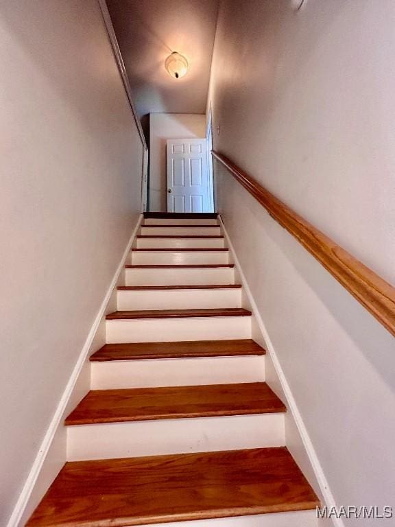 stairs featuring wood-type flooring