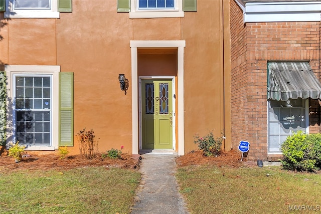 property entrance with a yard