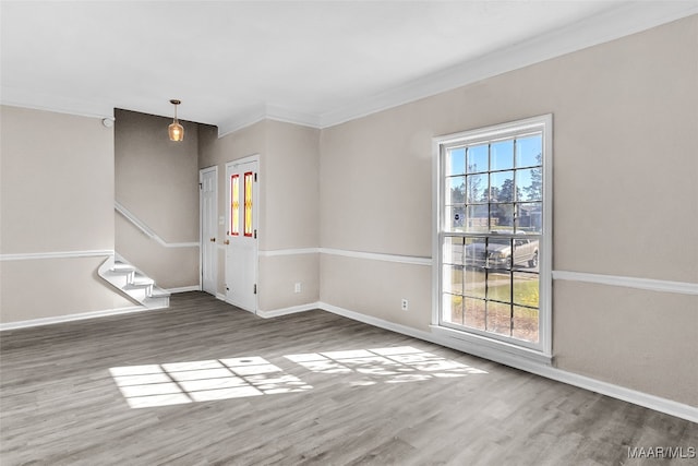 empty room with plenty of natural light, crown molding, and dark wood-type flooring