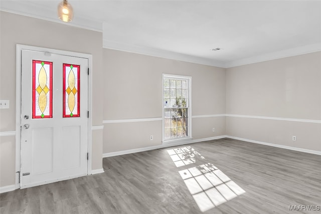 entryway with light wood-type flooring and crown molding