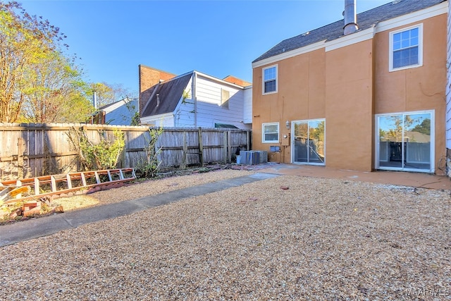 back of house with a patio and cooling unit