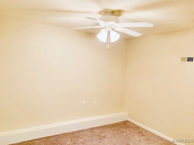 unfurnished room with light colored carpet and ceiling fan