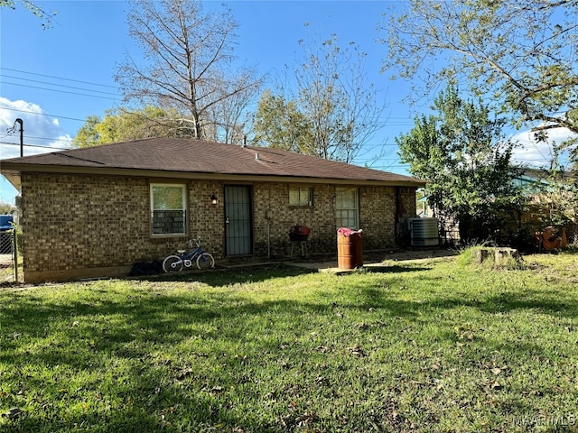 back of house featuring cooling unit and a yard