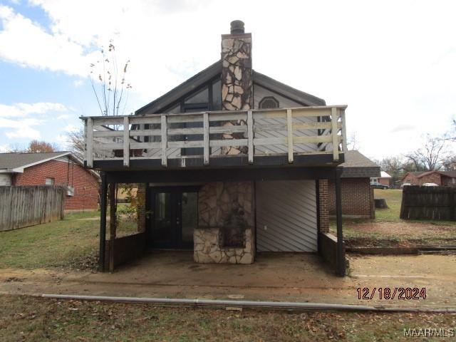 back of property featuring a deck