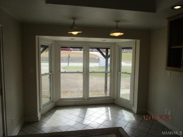 doorway to outside featuring light tile patterned flooring