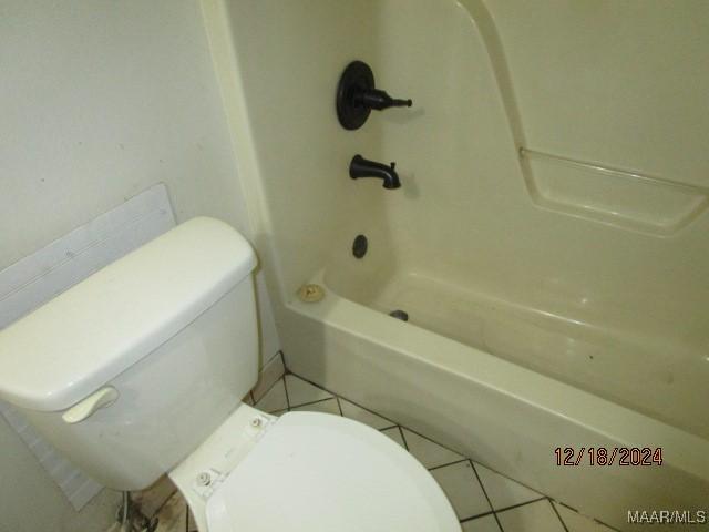 bathroom with tile patterned flooring, toilet, and shower / bath combination