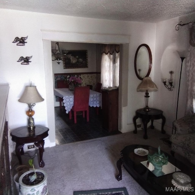 carpeted living room with a textured ceiling