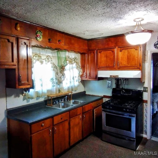 kitchen with stainless steel gas stove, a textured ceiling, and sink