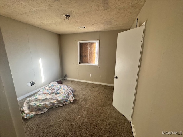 unfurnished bedroom with carpet flooring and a textured ceiling