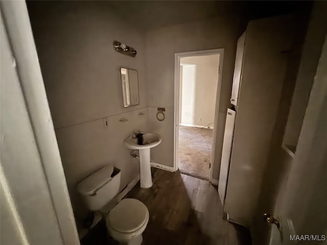 bathroom featuring wood-type flooring and toilet