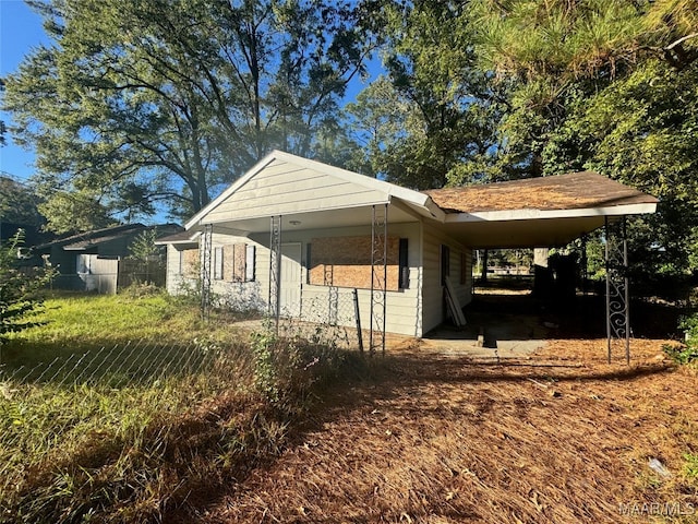 view of side of property featuring a carport