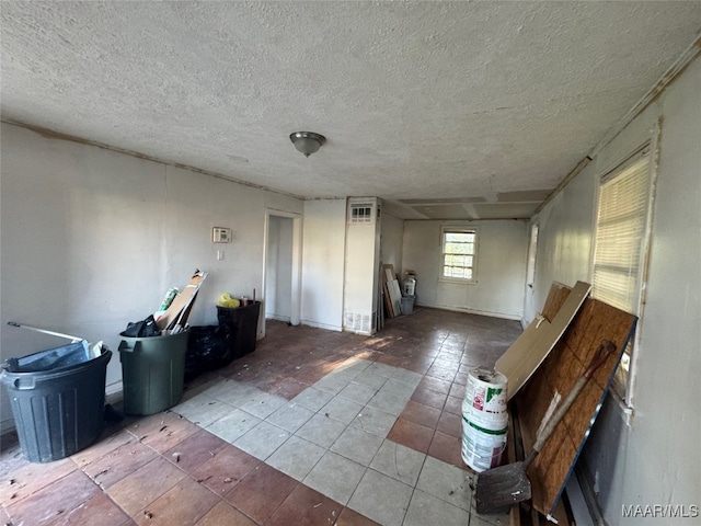 miscellaneous room featuring light tile patterned floors and a textured ceiling