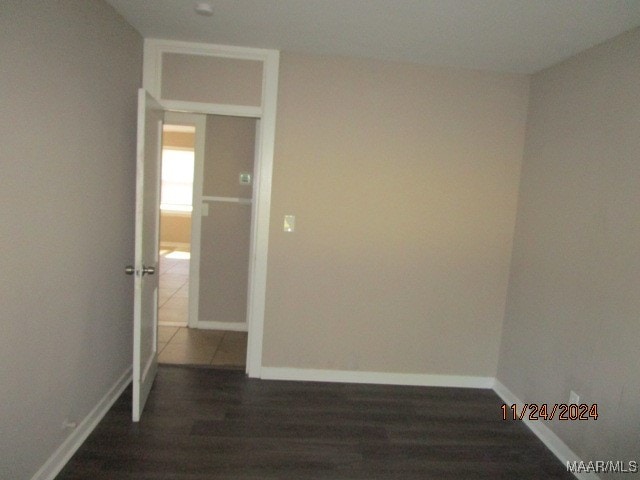 spare room featuring dark wood-type flooring