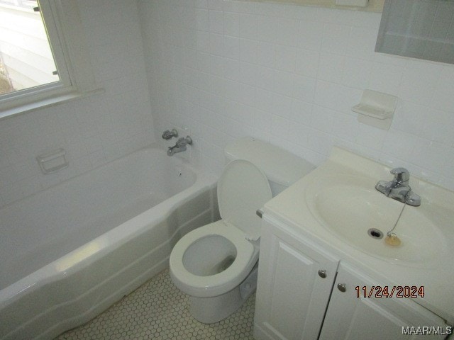 bathroom featuring vanity, tile walls, and toilet