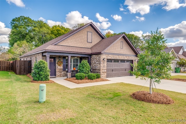 craftsman inspired home featuring a front yard and a garage