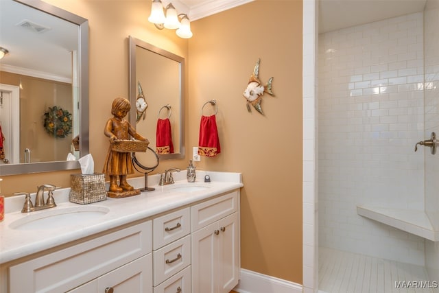 bathroom with a tile shower, crown molding, tile patterned floors, and vanity