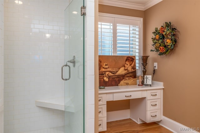 bathroom with hardwood / wood-style flooring, a shower with door, and crown molding