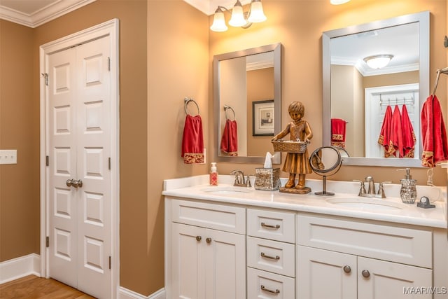 bathroom with hardwood / wood-style floors, vanity, and ornamental molding