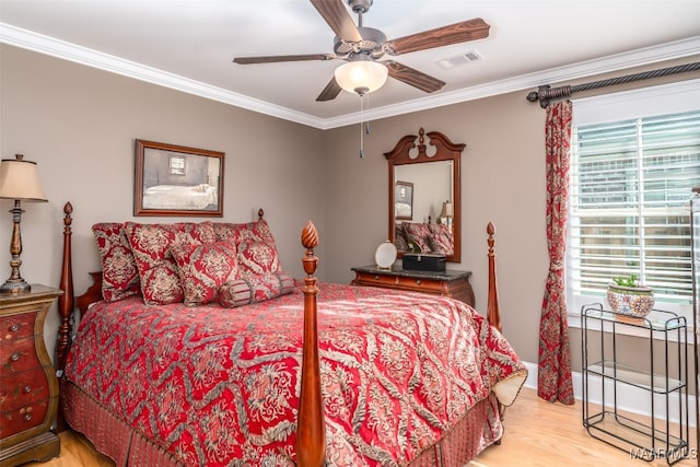 bedroom with ceiling fan, crown molding, and light hardwood / wood-style floors