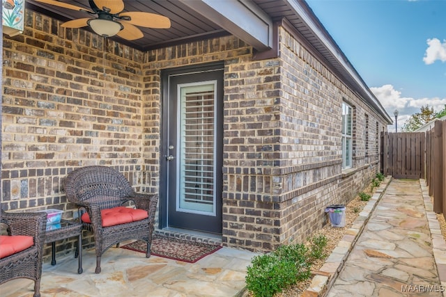 property entrance featuring ceiling fan and a patio area