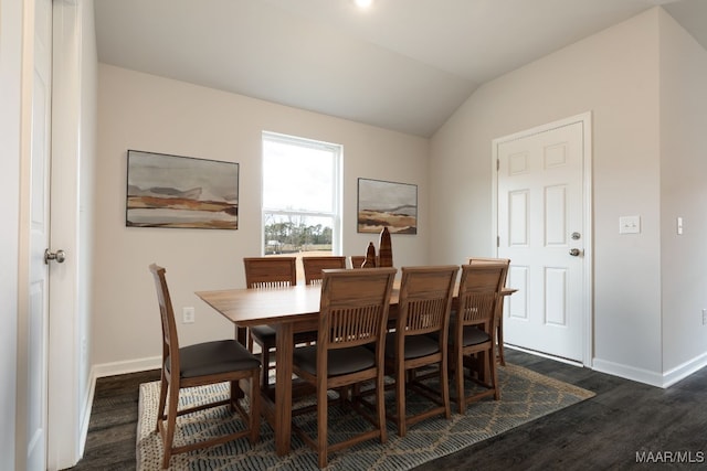 dining room featuring lofted ceiling and dark hardwood / wood-style floors