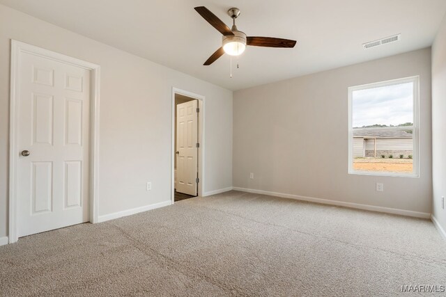 unfurnished bedroom featuring carpet and ceiling fan