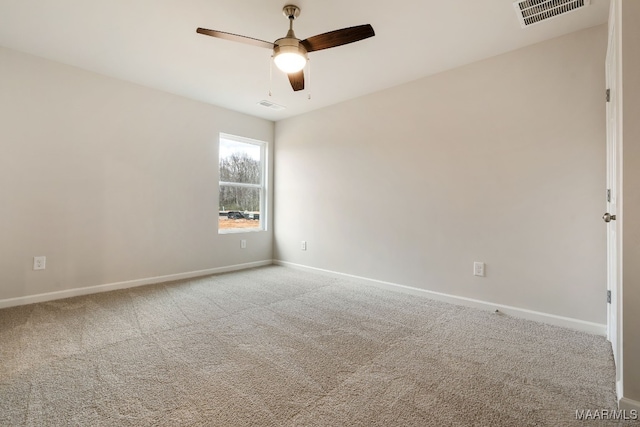 spare room with ceiling fan and light colored carpet