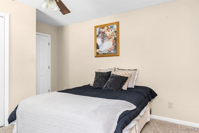 bedroom with light carpet, a textured ceiling, and ceiling fan