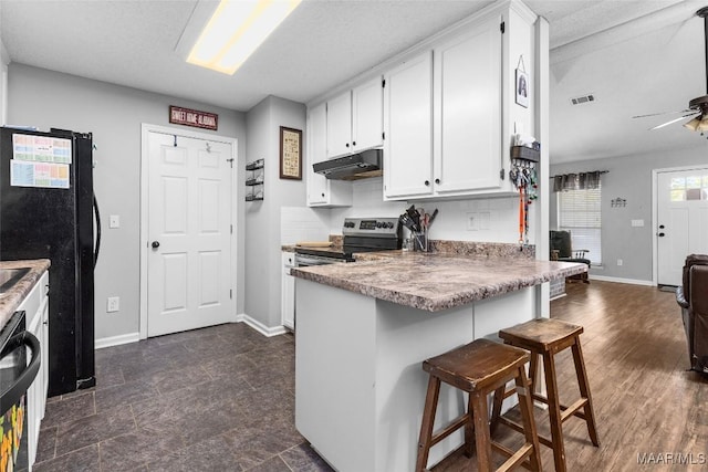 kitchen featuring white cabinetry, ceiling fan, a kitchen breakfast bar, kitchen peninsula, and black appliances