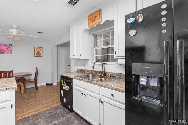 kitchen featuring a sink, a ceiling fan, visible vents, white cabinetry, and black appliances