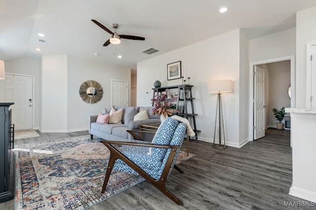 living room with ceiling fan and dark wood-type flooring