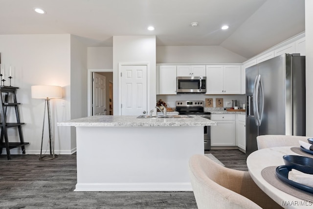 kitchen with white cabinets, appliances with stainless steel finishes, sink, and an island with sink