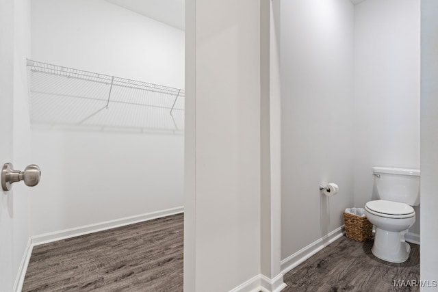 bathroom with hardwood / wood-style floors and toilet