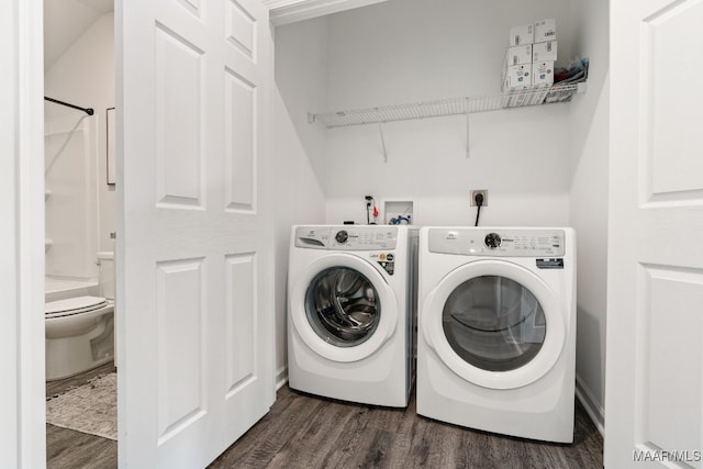 laundry room with dark hardwood / wood-style floors and washing machine and clothes dryer