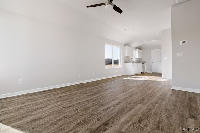 unfurnished living room featuring ceiling fan, dark wood-type flooring, and vaulted ceiling