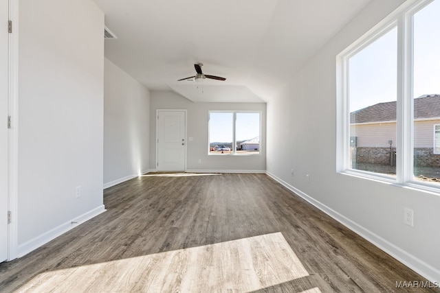 unfurnished living room with ceiling fan, lofted ceiling, and wood-type flooring