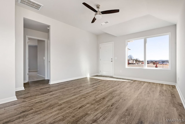 spare room with ceiling fan and dark hardwood / wood-style floors