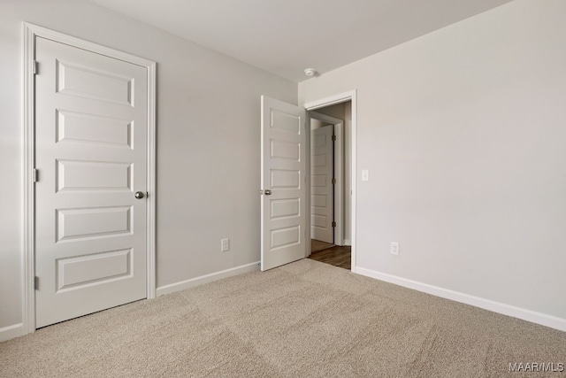 unfurnished bedroom featuring light carpet